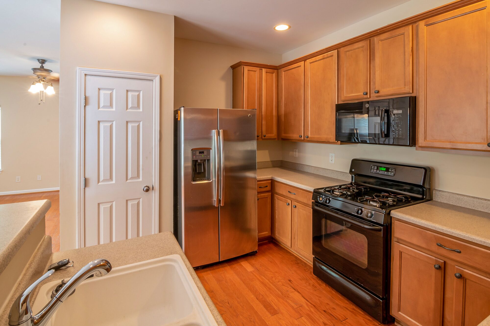 Kitchen with refrigerator and wood cabinetry